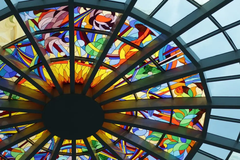A colorful stained glass dome ceiling showcasing intricate designs and vibrant patterns.